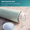 Närbild av det självslipande bladet på Silky Planet ansiktshårborttagare på marmorunderlag.